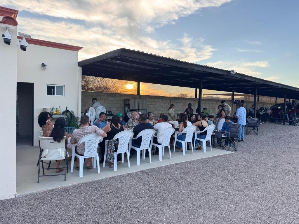 Guests dining outdoors at sunset at the By The Airport Storage customer appreciation event